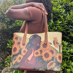 Flower Girl Tote - Vegan Leather Bag features original art of a smiling Black girl among sunflowers, ideal for stylish everyday use.