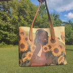 Flower Girl Tote - Vegan Leather Bag featuring original art of a smiling Black woman among sunflowers, perfect for stylish everyday use.